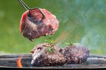 Grilled beef steaks on fire